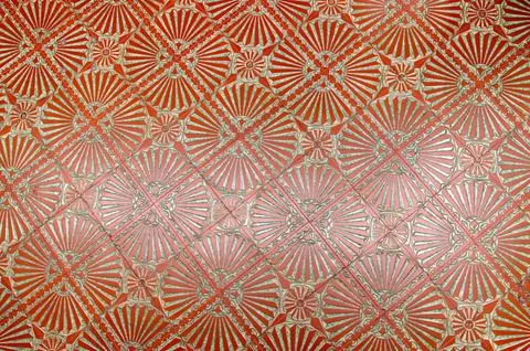 Decorative tile pattern displayed on textured wall surface Stock Photos