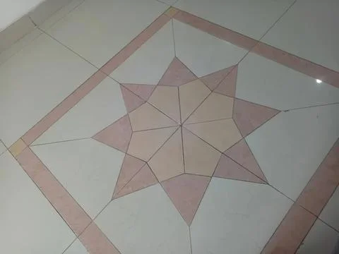Decorative tile with star pattern on floor surface Stock Photos