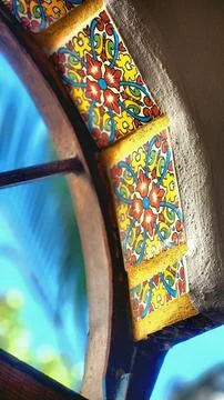Decorative tiled edge on a window capturing vibrant colors under natural ligh Stock Photos