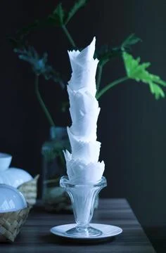 Decorative tissue cup lying with tissue inserted on a wooden table Stock Photos
