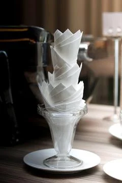 Decorative tissue cup lying with tissue inserted on a wooden table in a room. Stock Photos