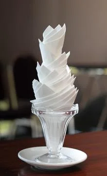 Decorative tissue cup lying with tissue inserted on a wooden table Stock Photos