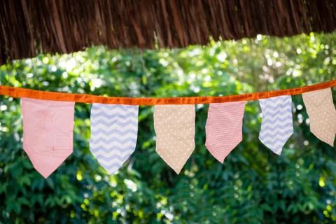 Decorative triangular and square party flags and lamps on trees, toned and wi Stock Photos