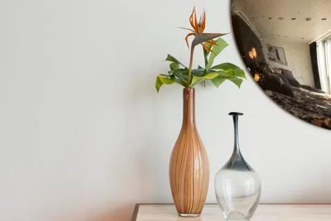 Decorative Vases On Table with Circular Mirror in Background Copy Space Stock Photos