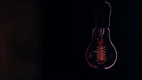 Decorative vintage light bulb hangs and shines in the dark copy space. Stock Footage 146137033