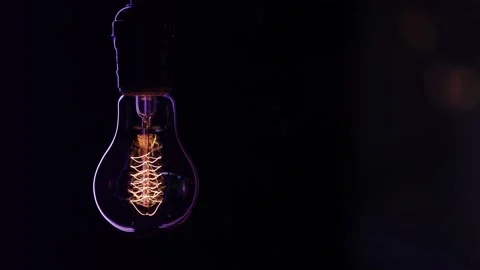 Decorative vintage light bulb hangs and shines in the dark copy space. Stock Footage 146369826