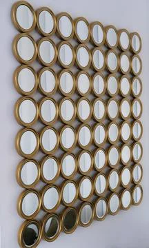Decorative wall arrangement featuring multiple round mirrors in gold frames Stock-Fotos