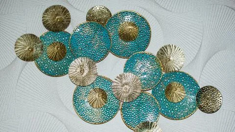 Decorative wall art display featuring blue and gold circular elements in modern Stock Photos