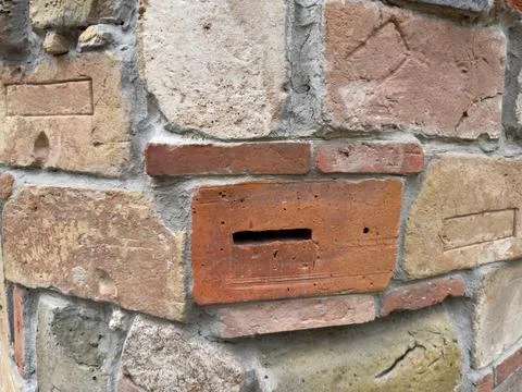 Decorative wall build with various old bricks and building blocks Stock Photos