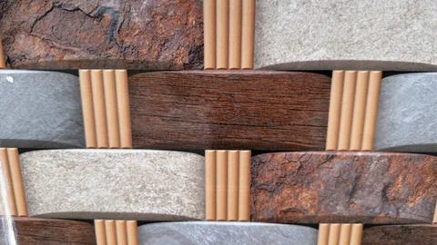A decorative wall features textured stone and wood like elements Stock Photos