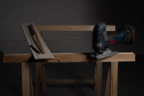 Decorative wall panel board prepared for cutting with jigsaw on workbench Stock Photos