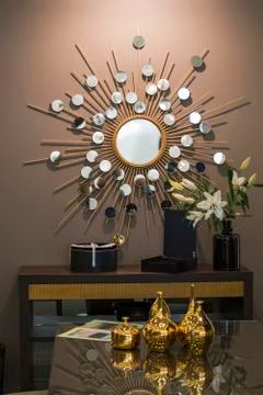 Decorative wall round mirror in the shape of the sun, a golden cooper mirror, Stock Photos