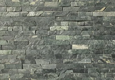 Decorative wall texture, background. Backdrop of a grey brick surface Stock Photos