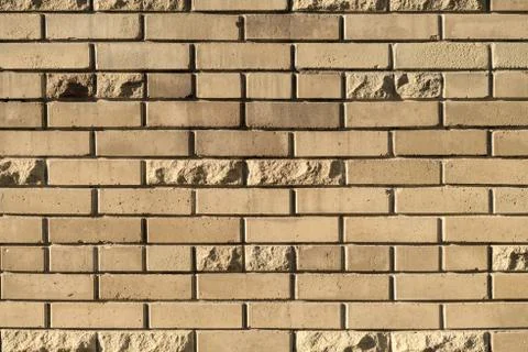 Decorative wall of yellow bricks. As a background or texture. Stock Photos