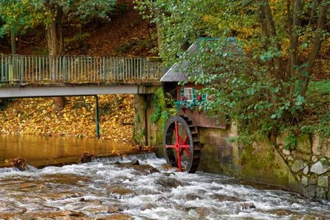 Decorative water mill in the forest. Stock Photos