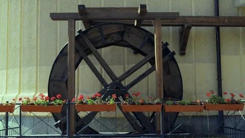 Decorative Water Mill Rotates in the Park near the Restaurant Stock Footage 119495053