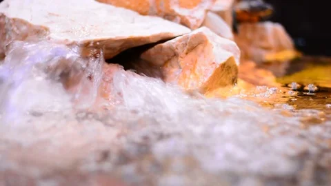 Decorative water source at city mall with stones and light. Stock Footage 83444841