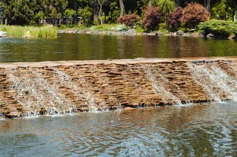 Decorative waterfall in the lake in the park Stock Photos