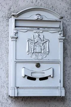Decorative White Metal Mailbox Mounted on Exterior Residential Wall Fotos Stock