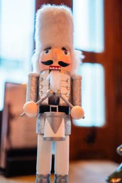 Decorative White Nutcracker With White Fur Bearskin Hat a Silver Costume an.. Stock Photos