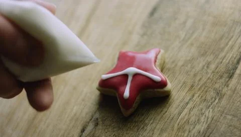 Decorative White Pattern Drawn Across a Red Star Cookie Stock Photos