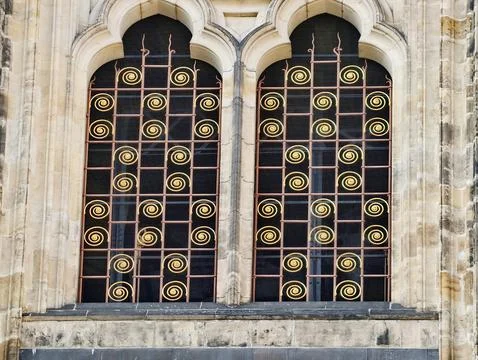 Decorative window design. Historic facade featuring elaborate metalwork and.. Stock Photos