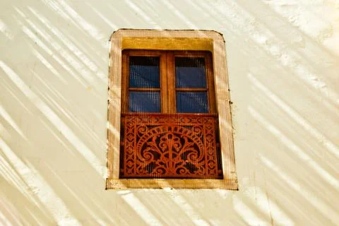 Decorative window in sunlight and shadow Foto stock