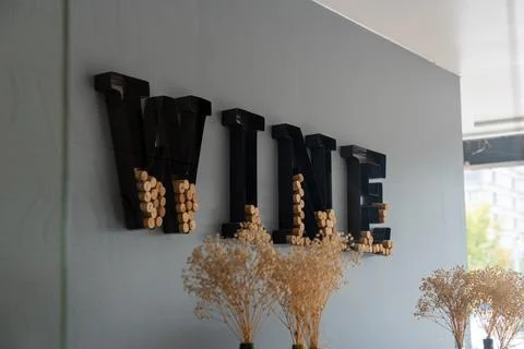 Decorative WINE sign on a wall filled with natural wine corks Stock Photos