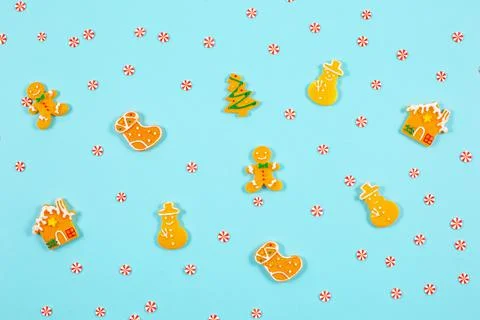 Decorative winter pattern from various gingerbread cookies on blue background. Stock Photos