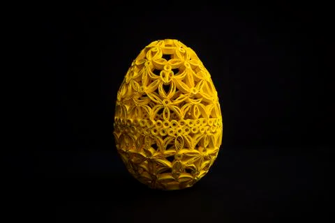 Decorative yellow Easter egg on a black background. Stock Photos