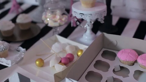 Decorator Decorates a Sweet Table For a Children's Holiday Stock Footage 77496253