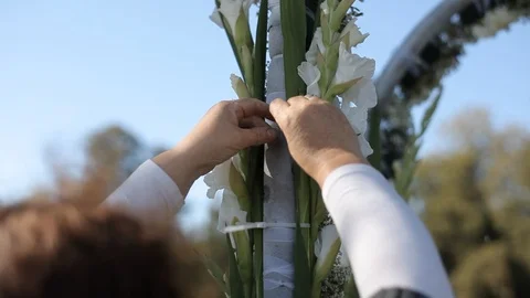 Decorator makes Beautiful wedding arch with  white flowers Stock Footage 105000208