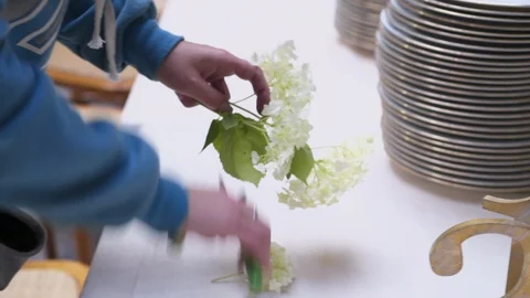 Decorator makes wedding table with with flowers  and glasses in the restaurant Stock Footage 105002737