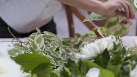 Decorator makes wedding table with with flowers  and glasses in the restaurant Stock Footage 105002818