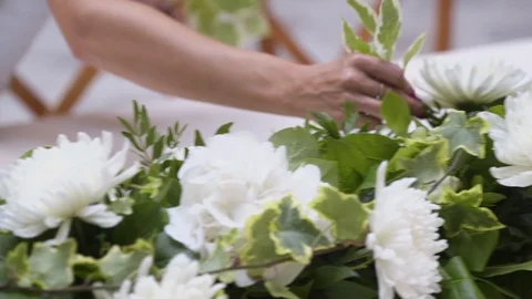 Decorator makes wedding table with with flowers  and glasses in the restaurant Stock Footage 105003267