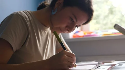 Decorator sits at desk and develops sketch fulfilling order Video stock 118221710
