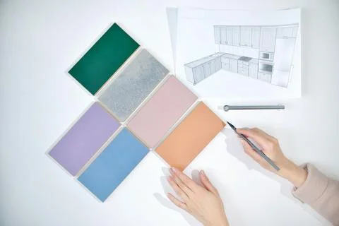 Decorator's hands Choosing samples of materials and colors of woods for inter Stock Photos