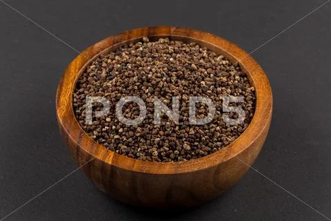 Decorticated cardamom seeds in a bowl Stock Photos