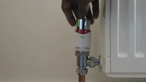 Decrease heating using TRV on thermostat Stockbeeldmateriaal 168256482