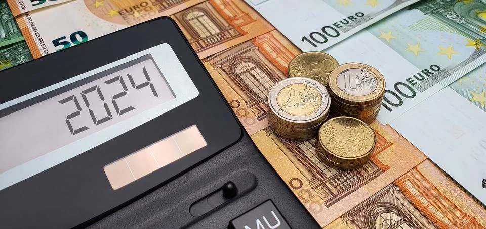 Decrease in income and salary in 2024. Calculator banknotes and euro coins Stock Photos