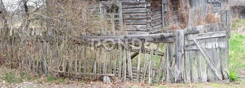 Decrepit wooden fence of the village house Stock Photos