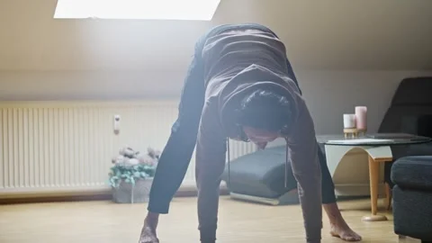 Dedicated and Focused Individual Working on Their Fitness by Exercising at Home Stock Footage 302655138