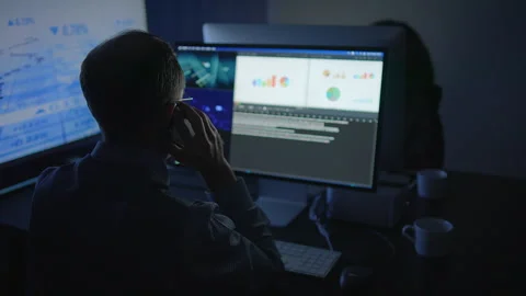 Dedicated and Focused Professional Expertly Analyzing Complex Data on Dual Stock Footage 294639061