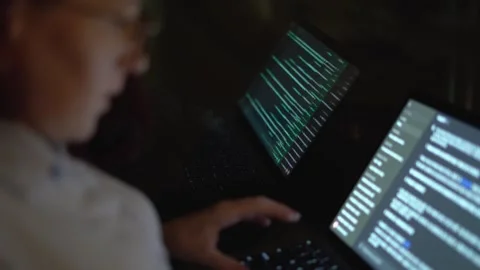 A dedicated and focused programmer deeply engrossed in coding while working on Stock-Footage 289967427