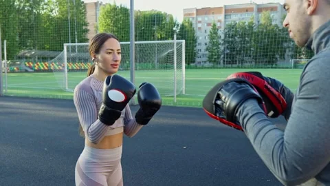 Dedicated athlete perfects boxing techniques while training with coach Video stock 316084651