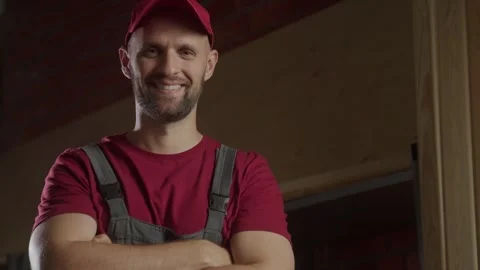 A dedicated carpenter stands proudly in a rustic workshop, showcasing his Stock Footage 281673432