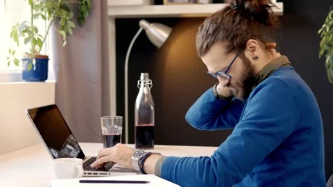 Dedicated Caucasian programmer typing on laptop and having neckpain. Stock Footage 141379700