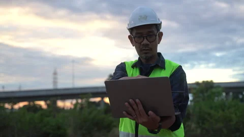 A dedicated construction engineer or supervisor wearing safety gear examine.. Stock Footage 322041230