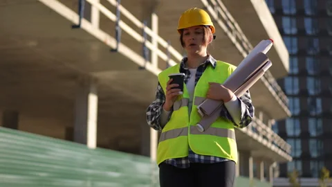 A dedicated construction professional is actively working on a bustling building Stock Footage 311863154
