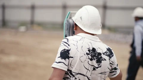 A dedicated construction worker is utilizing advanced survey equipment at the Stock Footage 312635100